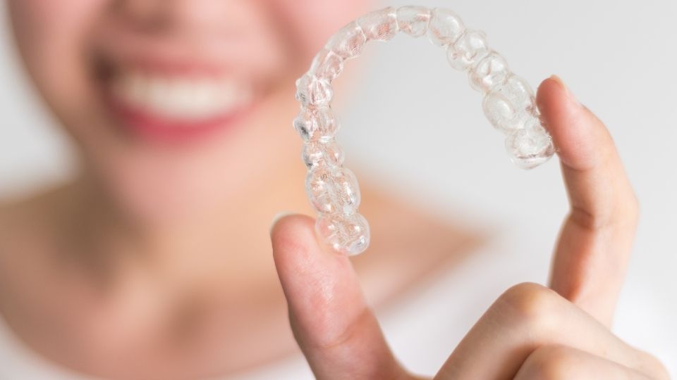 Invisalign Dental Treatment in Everett Redmond and Woodinvilee washington eckland family dentistry women holding invisalign