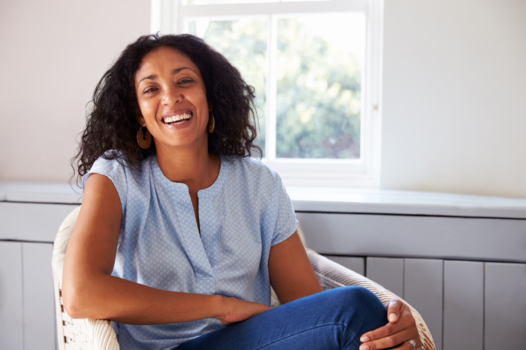 Beautiful smiling woman sitting in a chair