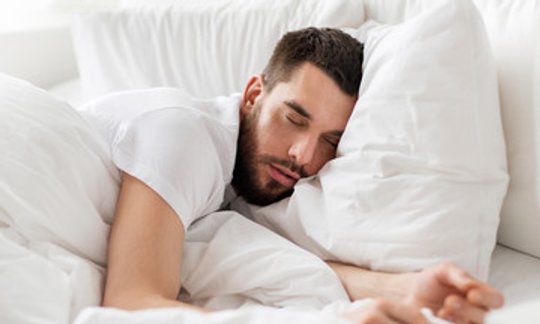 Man sleeping restfully after sleep apnea treatment